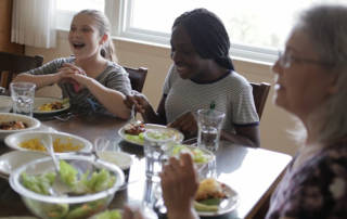 Children sit around a table with an adult. Photo for Masonic Children's Home Renovations.